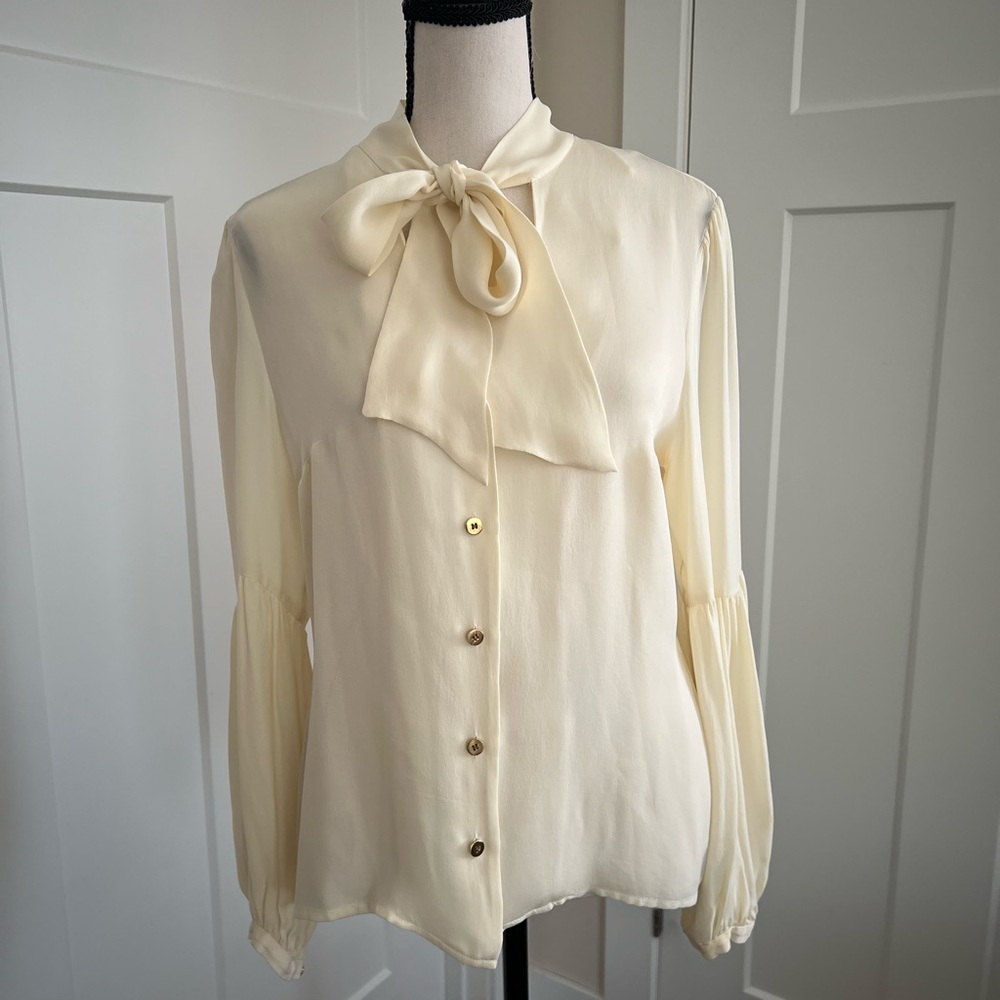 Designer sheer ivory silk button down with tie at neck.
